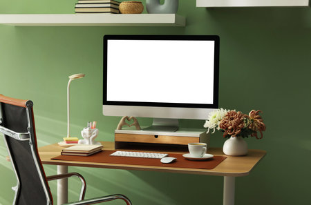Stylish workplace with computer and brown mat on desk in officeの写真素材