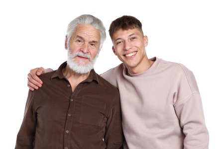 Son hugging his father on white backgroundの写真素材