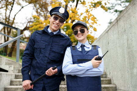 Portrait of smiling police officers on city street