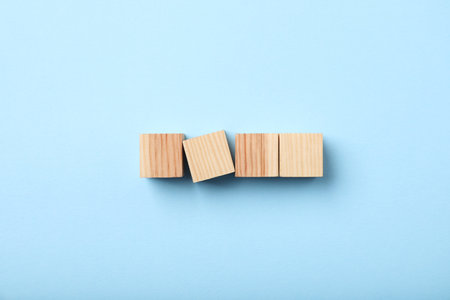Wooden cubes on light blue background, top viewの写真素材