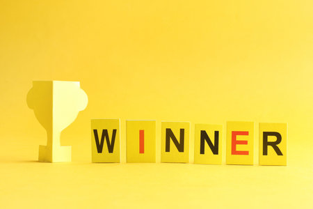 Cards with word Winner and paper trophy cup on backgroundの写真素材