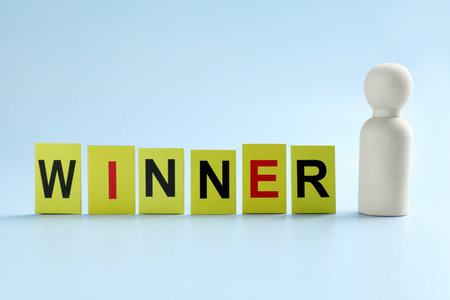 Cards with word Winner and human figure on light blue backgroundの写真素材
