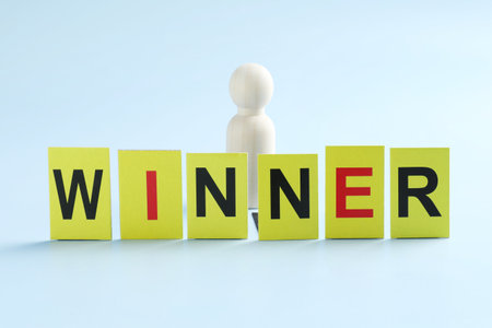 Cards with word Winner and human figure on light blue backgroundの写真素材