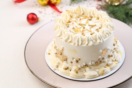 Delicious cake with Christmas decor on white table, closeup