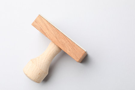 One wooden stamp on white background, top view. Space for textの写真素材
