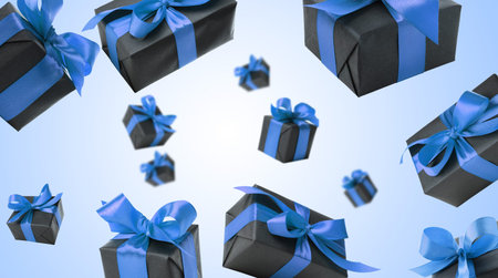 Gift boxes flying in air on blue gradient background