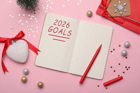 New 2026 Year Goals. Inscription in notebook on table with festive stuff, top viewの写真素材