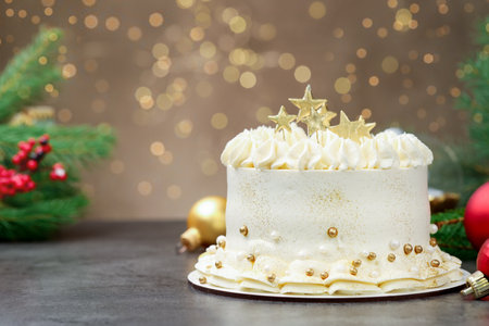 Delicious cake with Christmas decor on gray table against blurred lights, closeup. Space for textの写真素材