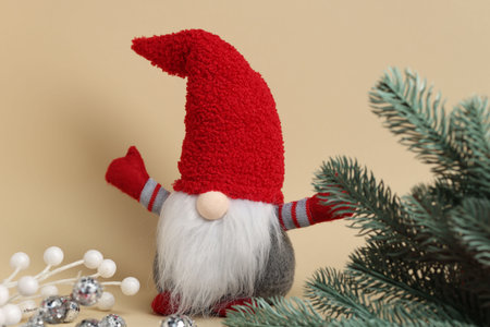 Funny Christmas gnome and festive decor on beige background, closeupの写真素材