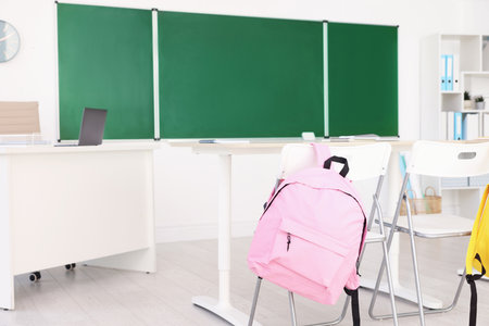 Green chalkboard and stylish furniture in classroom. Mockup for designの写真素材