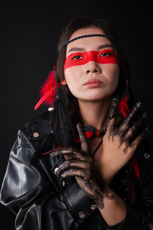 Shaman woman with face painting on black backgroundの写真素材