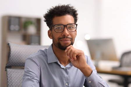Portrait of handsome man in shirt at workplaceの写真素材