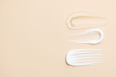 Samples of different cosmetic products on beige background, flat lay. Space for text