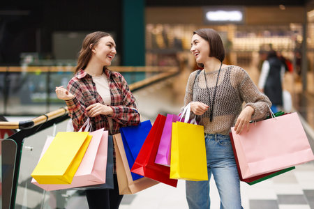 Women with different shopping bags in mall