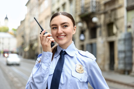 Police officer talking via radio on city streetの写真素材