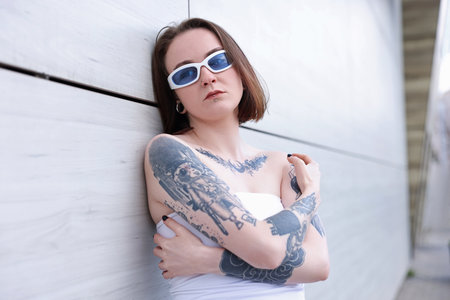 Young woman with piercings and tattoos outdoorsの写真素材