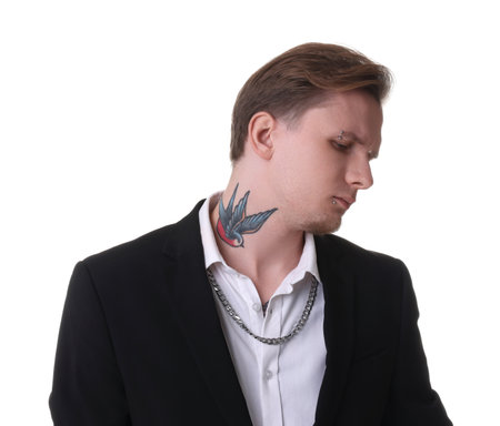 Young man with piercings, tattoos and stylish clothes posing on white backgroundの写真素材