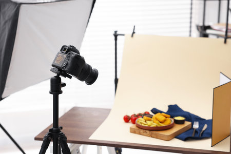 Shooting chicken nuggets, French fries, sauces and tomatoes with camera in studio. Professional food photographyの写真素材