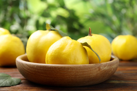 Fresh ripe quinces on wooden table outdoors, closeupの写真素材