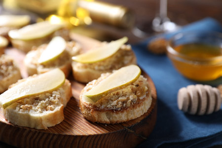 Tasty bruschettas with apples, honey and walnuts on table, closeupの写真素材