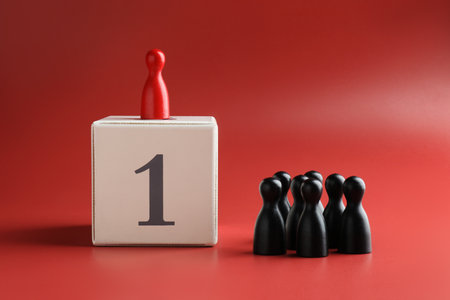 Winner. Human figures, red one on top of cube with number 1 against color backgroundの写真素材