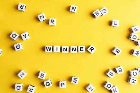 Word Winner made of cubes on orange background, flat layの写真素材