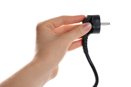 Hand holding electrical wire with plug on white background, closeupの写真素材