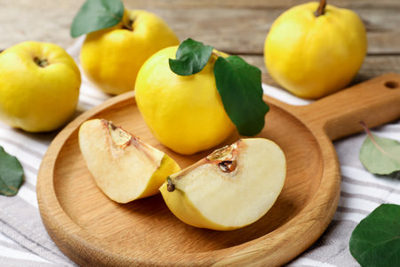Whole and cut ripe quinces on table, closeupの写真素材