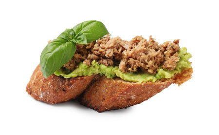 Delicious bruschetta with tuna, avocado and basil isolated on whiteの写真素材