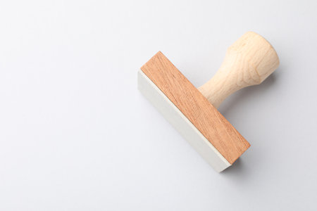 One wooden stamp on white background, top view. Space for textの写真素材