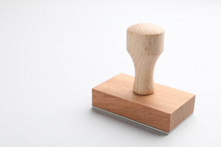 One wooden stamp on white background, closeup. Space for textの写真素材