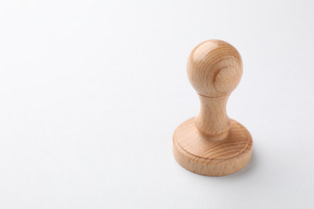One wooden stamp on white background, closeup. Space for textの写真素材