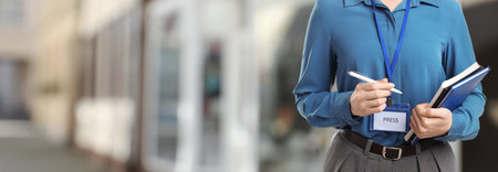 Journalist with pen and notebooks outdoors, closeup. Banner designの写真素材