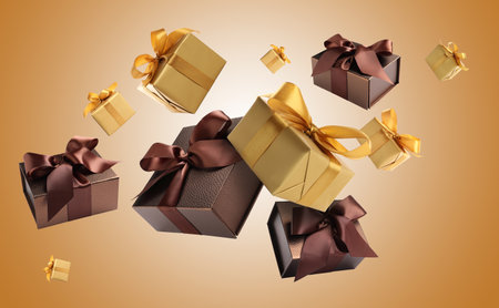 Gift boxes flying in air on golden gradient backgroundの写真素材
