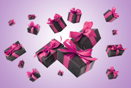 Gift boxes flying in air on violet gradient backgroundの写真素材