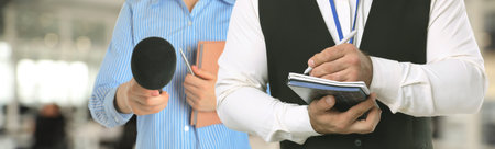 Journalists with microphone and notebooks indoors, closeup.の写真素材