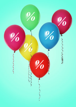 Colorful balloons with percent signs on turquoise backgroundの写真素材