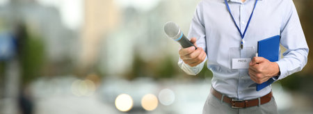 Person with microphone and notebook outdoors, closeup. Designの写真素材