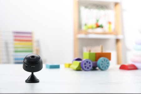 Camera on white table in child's room. Space for textの写真素材