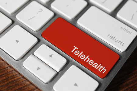 Red button with word Telehealth on computer keyboard, closeupの写真素材
