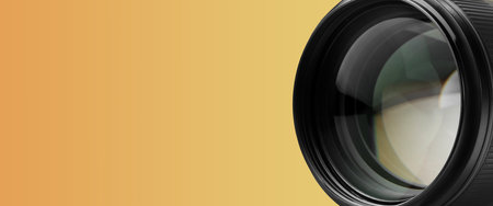 Camera lens on orange gradient background, closeup. Banner design with space for textの写真素材