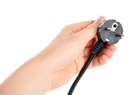 Woman holding plug on white background, closeup