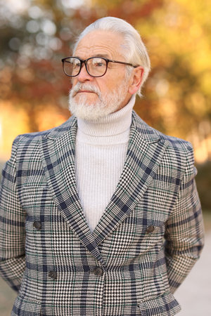 Handsome senior man with gray hair at parkの写真素材