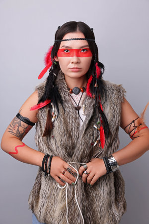 Shaman woman with face painting on light gray background