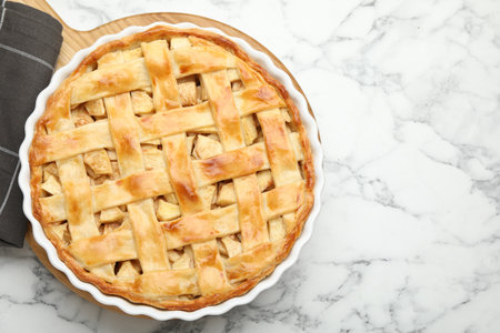 Tasty homemade apple pie on white marble table, top view. Space for textの写真素材