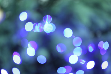 Beautiful blurred Christmas lights on color background, closeup. Bokeh effectの写真素材