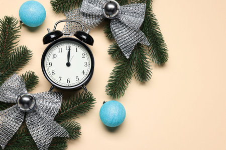 Alarm clock, fir tree branches, baubles and bows on beige background, flat lay with space for text....