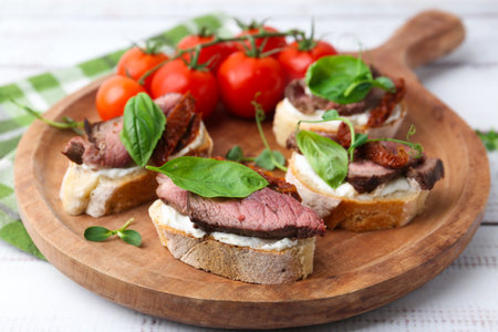 Bruschettas with roast beef served on white wooden table, closeupの写真素材