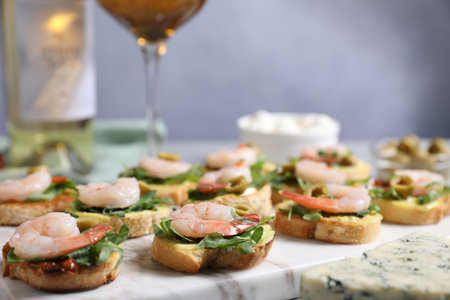 Delicious bruschettas with shrimps on light table, closeupの写真素材