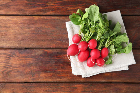 Fresh ripe radishes on wooden table, top view.